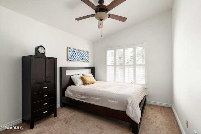 carpeted bedroom with ceiling fan and lofted ceiling