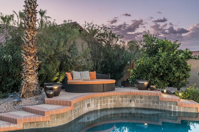 view of pool at dusk