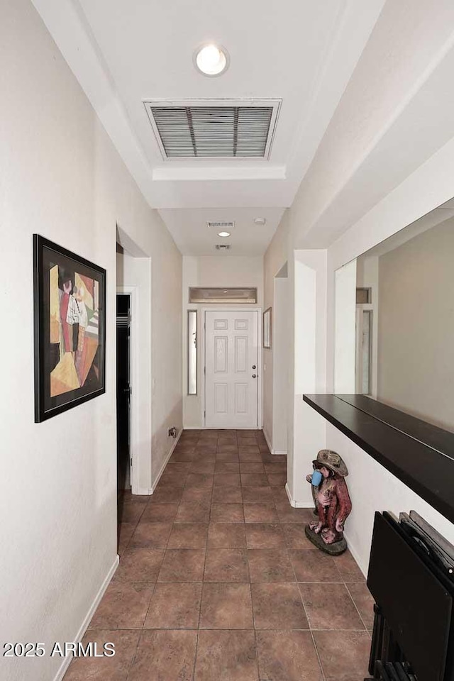 hall featuring dark tile patterned flooring