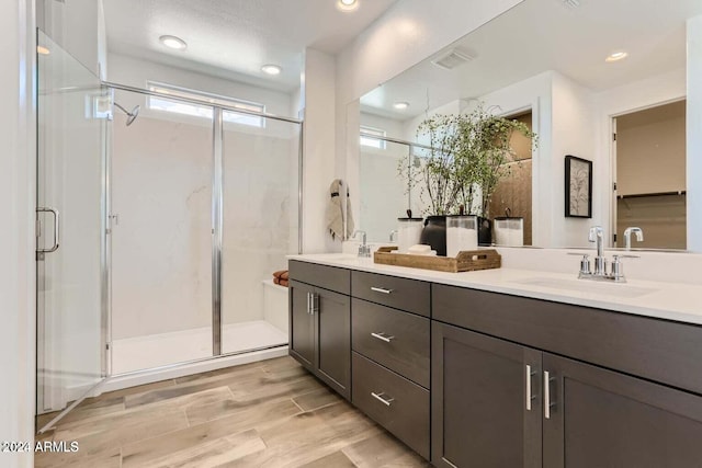 bathroom featuring vanity, hardwood / wood-style floors, and walk in shower