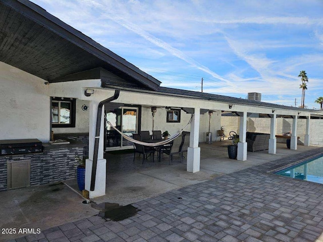 view of patio / terrace with a fenced in pool, a grill, and area for grilling