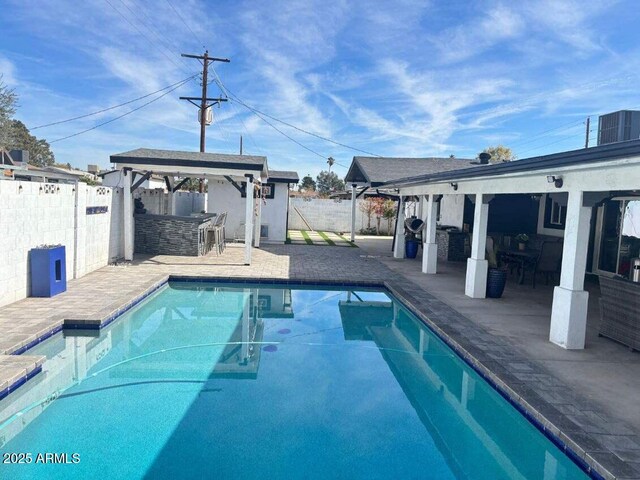 view of swimming pool with a gazebo, a patio area, and exterior bar