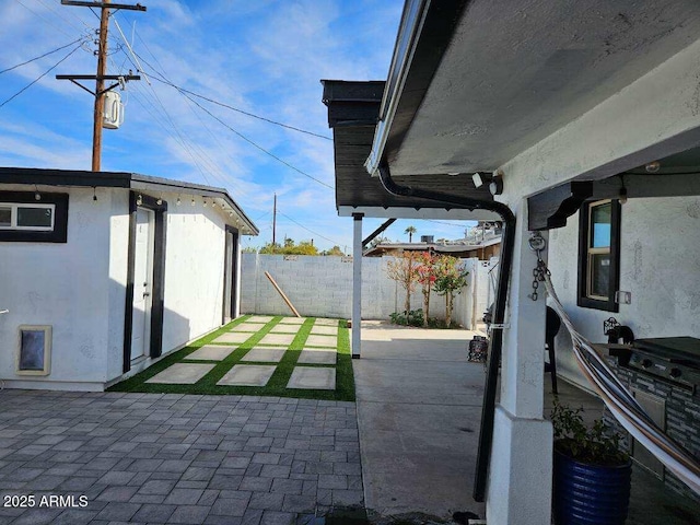 view of patio featuring an outbuilding