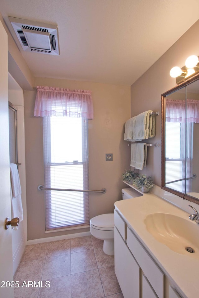 bathroom featuring vanity, tile patterned floors, toilet, and visible vents