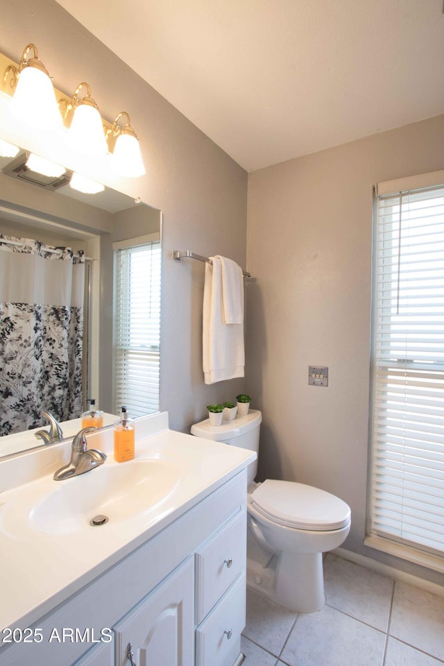 full bathroom with tile patterned flooring, a shower with shower curtain, toilet, and vanity