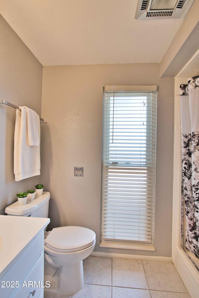 full bathroom with vanity, visible vents, tile patterned flooring, curtained shower, and toilet