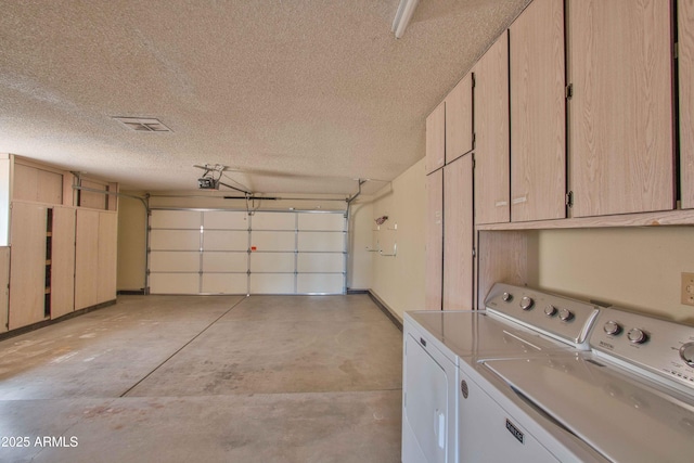 garage featuring a garage door opener and washer and clothes dryer