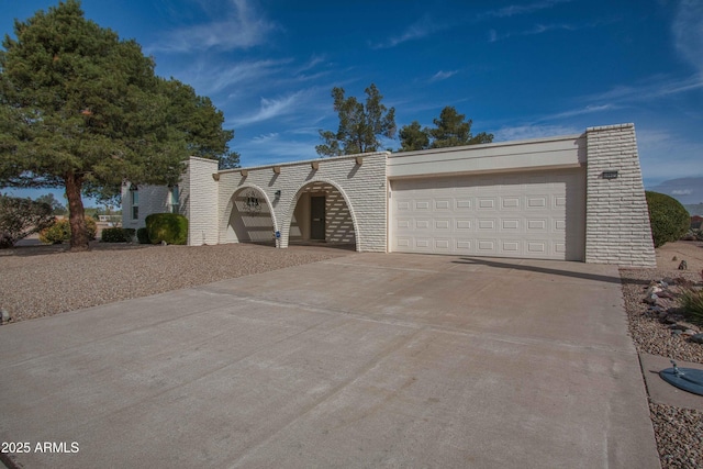 view of front of house featuring concrete driveway and an attached garage