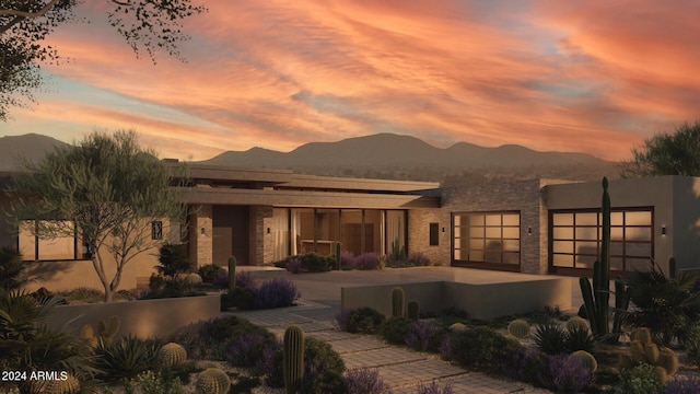 view of front of home featuring a mountain view and a patio area