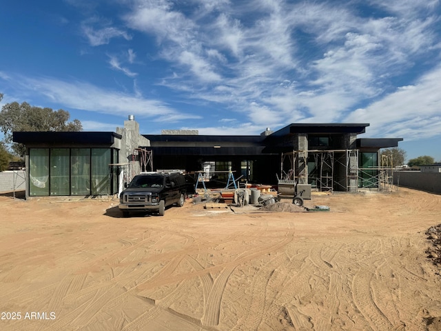 rear view of property with a carport