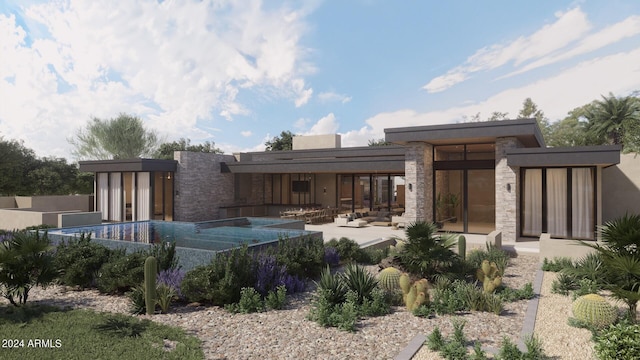 back of property with stone siding and a patio area