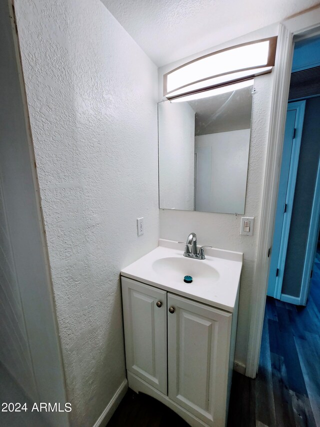 bathroom with vanity and hardwood / wood-style floors