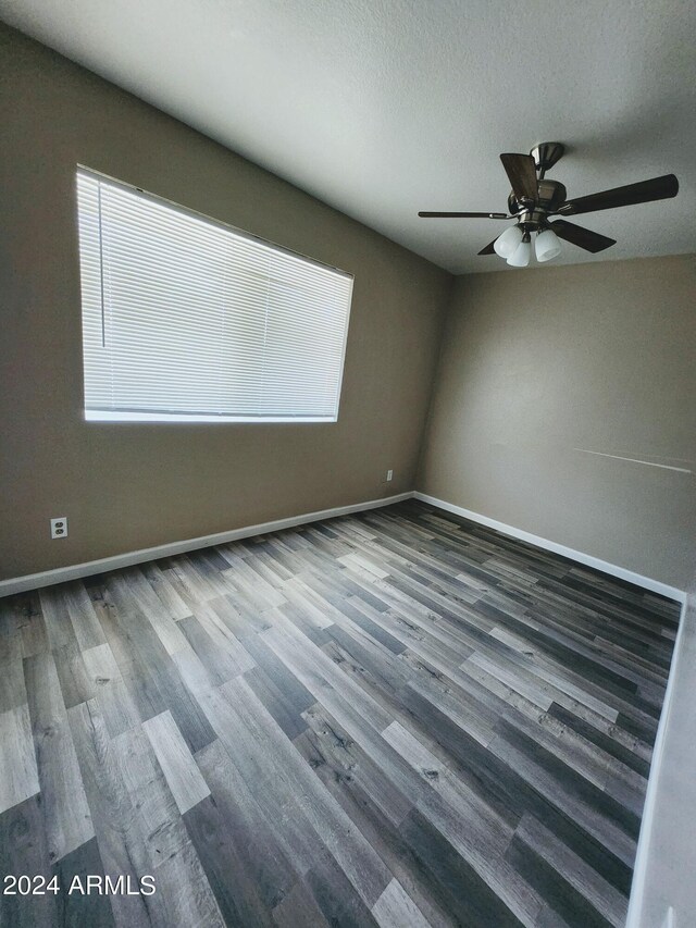 empty room featuring hardwood / wood-style flooring and ceiling fan