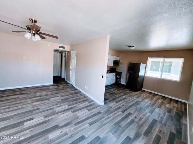 unfurnished living room with ceiling fan, a textured ceiling, and hardwood / wood-style flooring