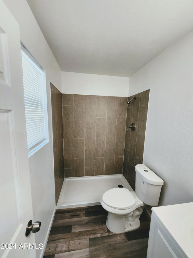 bathroom featuring wood-type flooring, toilet, and vanity