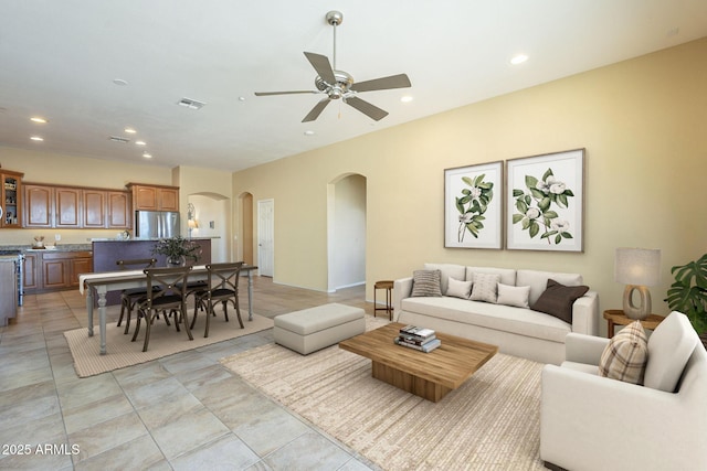 tiled living room with ceiling fan