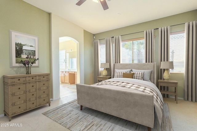 carpeted bedroom with connected bathroom and ceiling fan