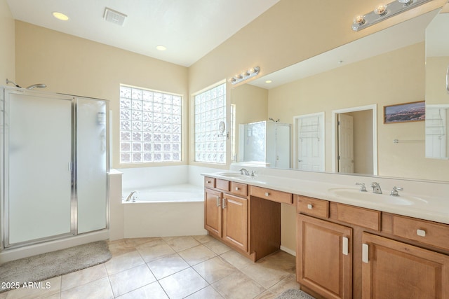 bathroom featuring tile patterned floors, vanity, and shower with separate bathtub