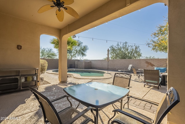 view of patio featuring ceiling fan and a fenced in pool