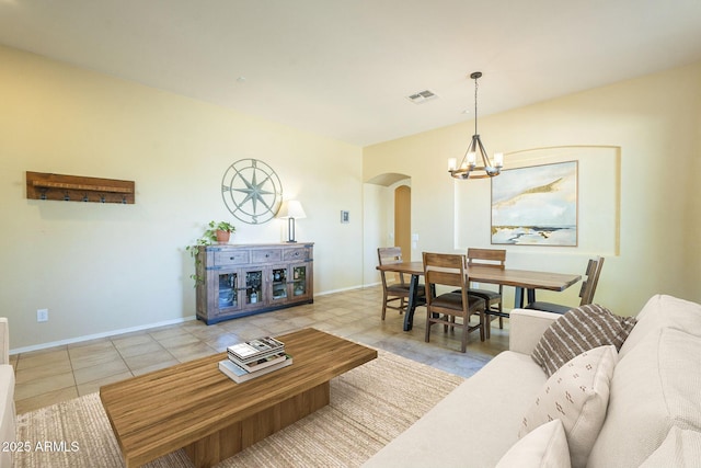 living room featuring a notable chandelier and light tile patterned floors