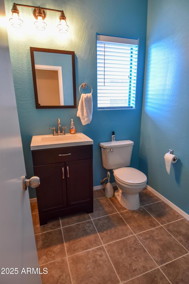 bathroom featuring vanity, toilet, and tile patterned flooring