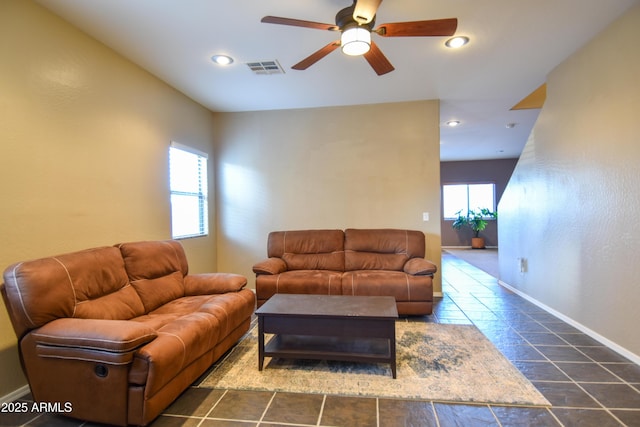 living room with a healthy amount of sunlight and ceiling fan