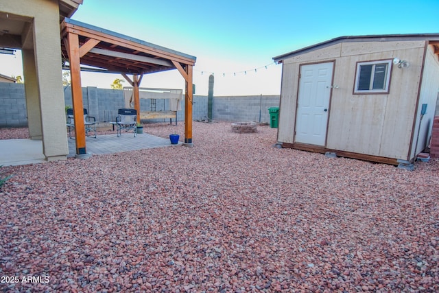 view of yard featuring a patio area and a storage unit