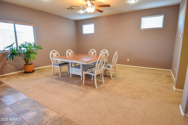 carpeted dining room featuring ceiling fan