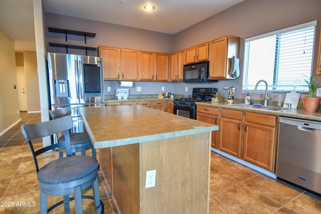 kitchen with light tile patterned flooring, a center island, sink, and black appliances