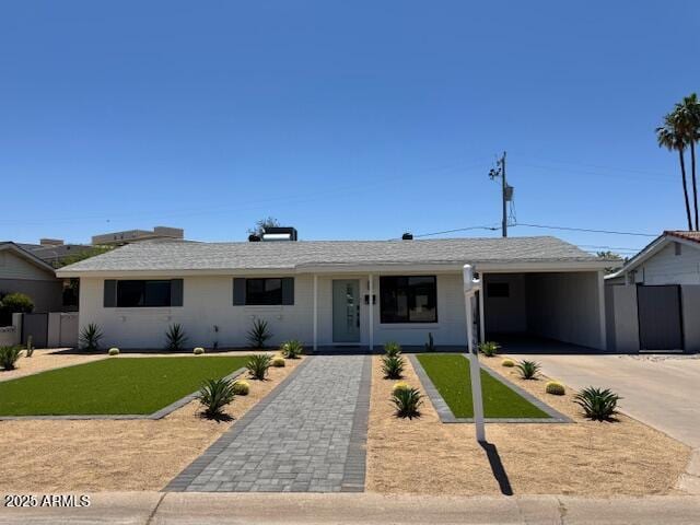6723 E 1st Ave, Scottsdale, AZ 85251 - ranch-style home with driveway and an attached carport