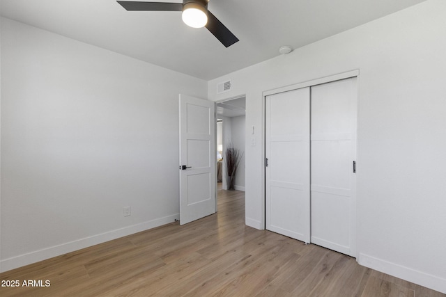 6723 E 1st Ave, Scottsdale, AZ 85251 - unfurnished bedroom with light wood-style flooring, baseboards, a closet, and a ceiling fan