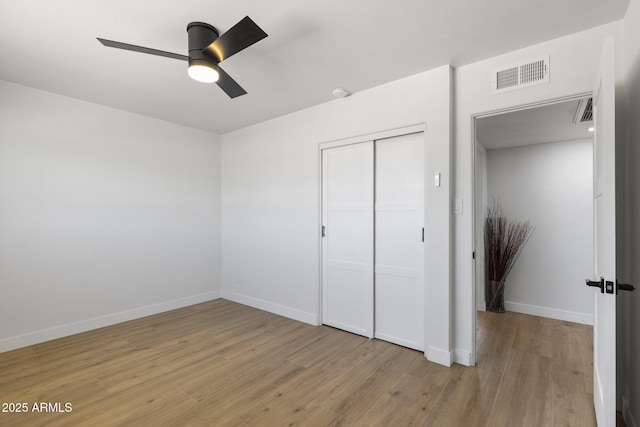 6723 E 1st Ave, Scottsdale, AZ 85251 - unfurnished bedroom with light wood-style flooring, a closet, baseboards, and ceiling fan