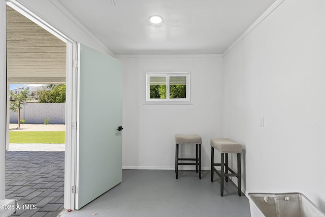6723 E 1st Ave, Scottsdale, AZ 85251 - spare room with plenty of natural light, finished concrete flooring, ornamental molding, and baseboards