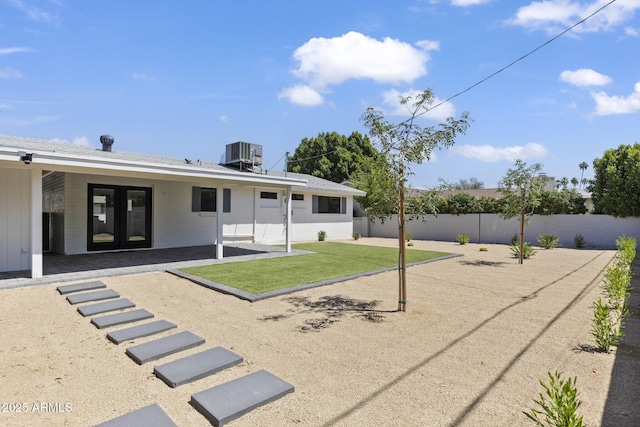 6723 E 1st Ave, Scottsdale, AZ 85251 - back of house with french doors, central AC unit, and a patio