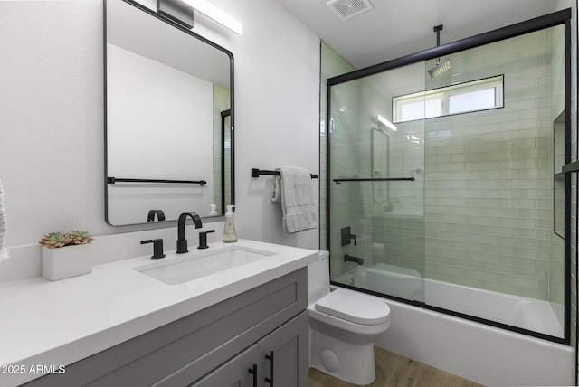 6723 E 1st Ave, Scottsdale, AZ 85251 - bathroom with vanity, toilet, a combined bath / shower with rainfall shower, and wood finished floors