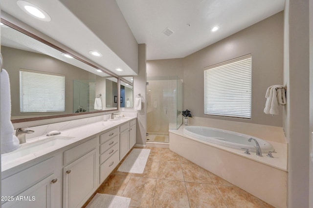 bathroom with a bath, a stall shower, double vanity, and a sink