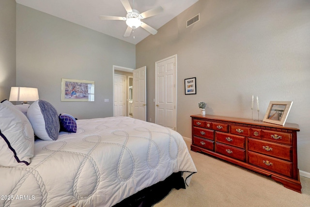 bedroom with high vaulted ceiling, a ceiling fan, visible vents, and light colored carpet