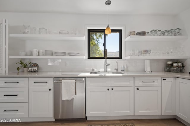 kitchen with sink, white cabinetry, decorative light fixtures, dishwasher, and decorative backsplash