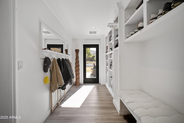 mudroom featuring crown molding and light hardwood / wood-style floors