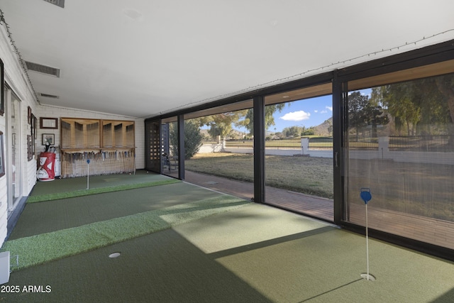 unfurnished sunroom featuring golf simulator and vaulted ceiling