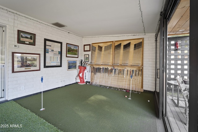 interior space featuring vaulted ceiling, brick wall, and carpet floors