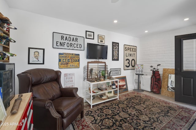 living area with brick wall