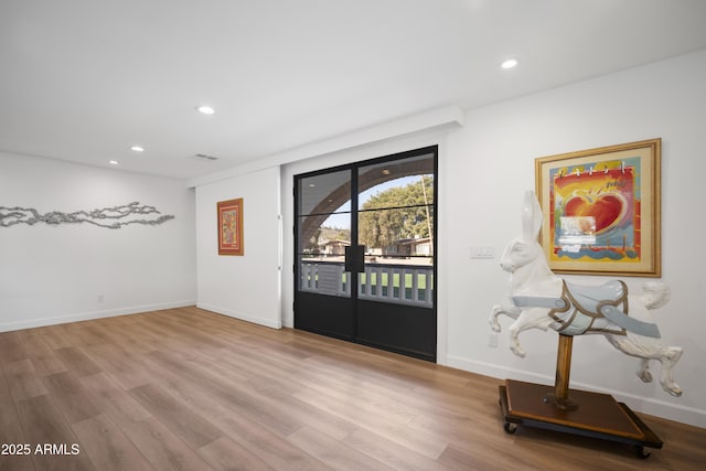 entrance foyer featuring light hardwood / wood-style floors