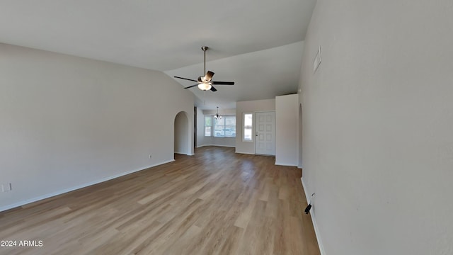 unfurnished living room featuring vaulted ceiling, light wood-type flooring, and ceiling fan