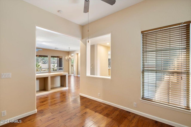 15120 E Vermillion Dr, Fountain Hills, AZ 85268 - spare room featuring baseboards, hardwood / wood-style flooring, and ceiling fan with notable chandelier