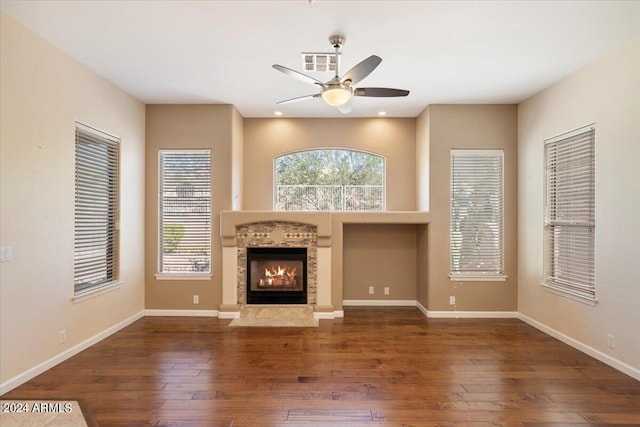 unfurnished living room with ceiling fan and dark hardwood / wood-style floors