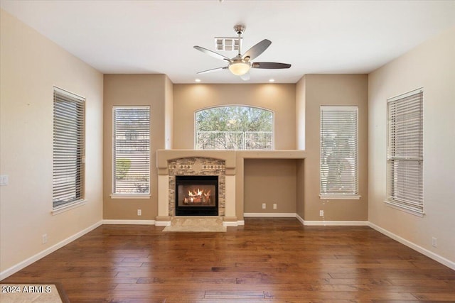 15120 E Vermillion Dr, Fountain Hills, AZ 85268 - unfurnished living room with a ceiling fan, visible vents, a tiled fireplace, baseboards, and hardwood / wood-style floors