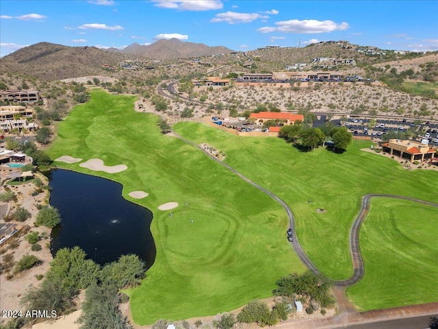 birds eye view of property with a water and mountain view