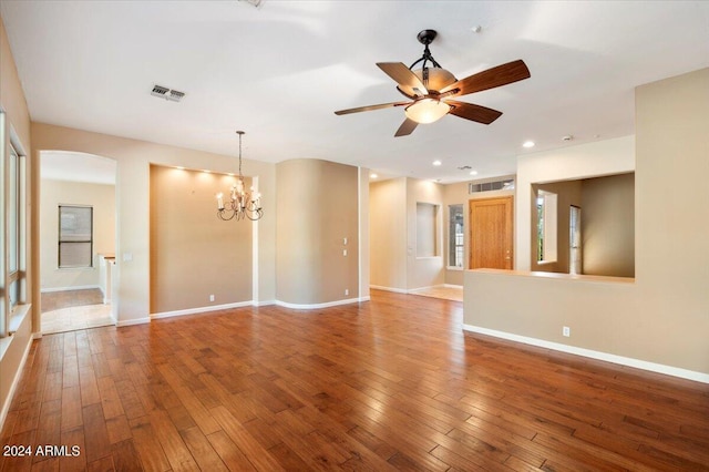 spare room featuring hardwood / wood-style flooring and ceiling fan with notable chandelier