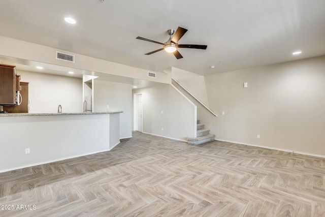 unfurnished living room with light parquet floors and ceiling fan